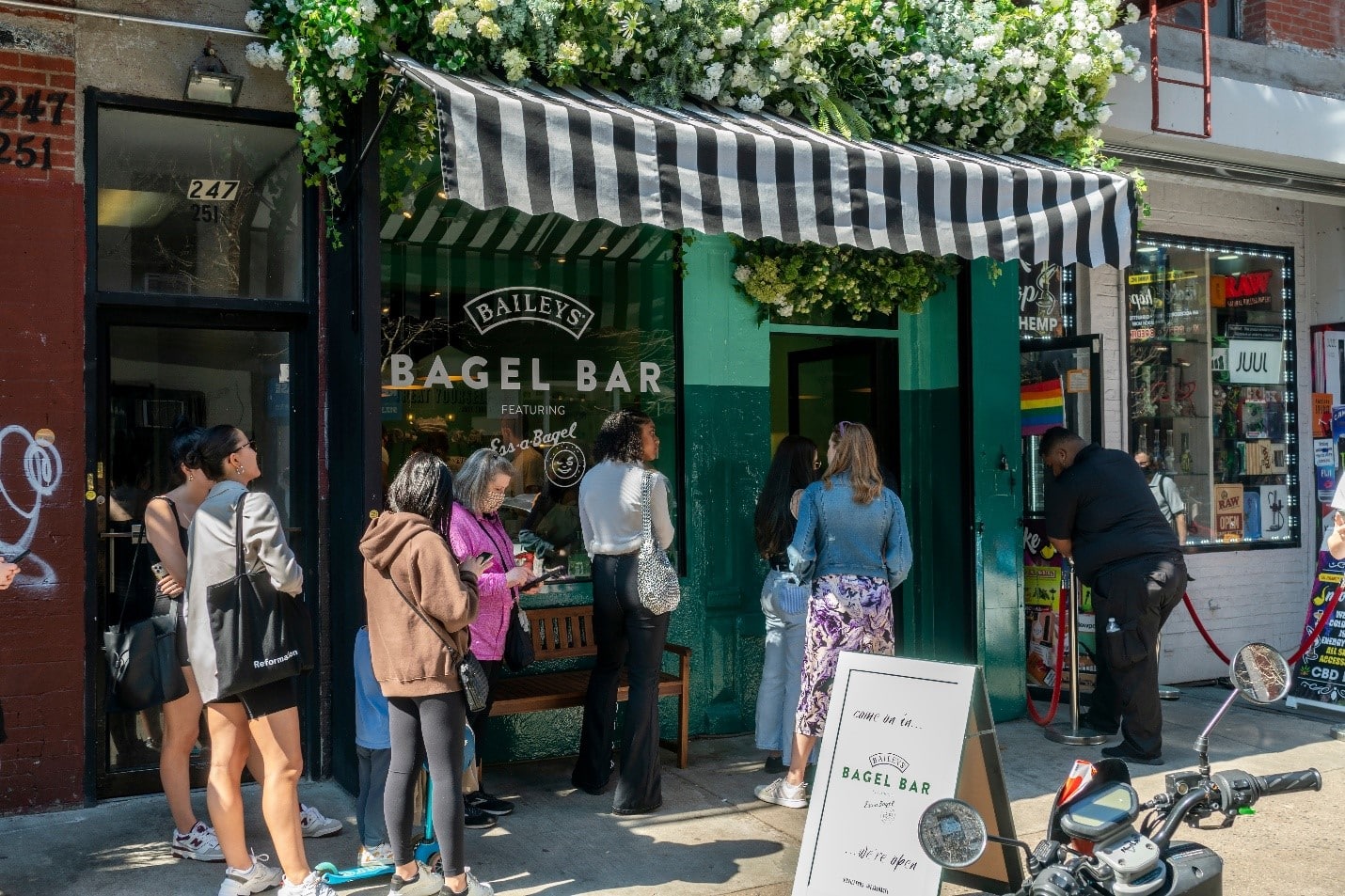People standing outside a bagel bar during a New York City travel guide