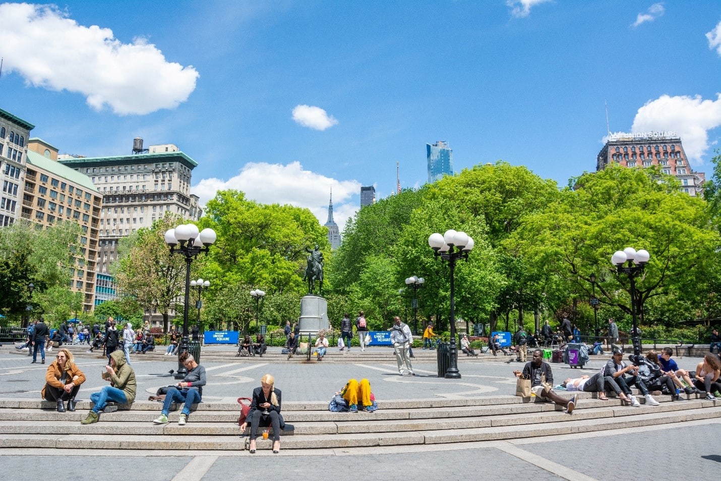 People sitting around in Washington Park during a New York City travel guide