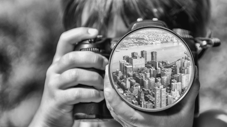 A lens with buildings in the reflection seen duringNew York City travel guide