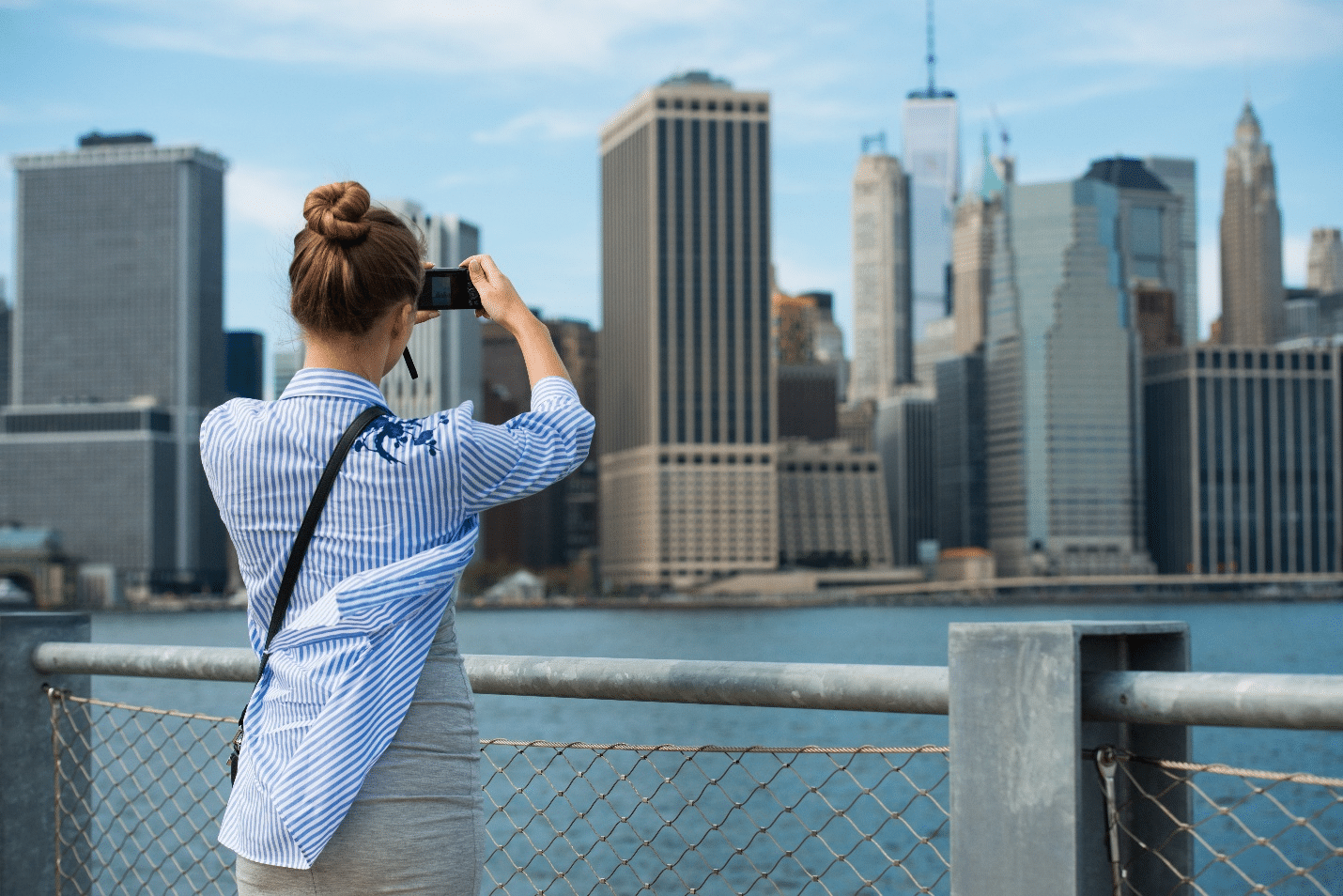 A woman taking photos of buildings during aone-day sightseeing tour