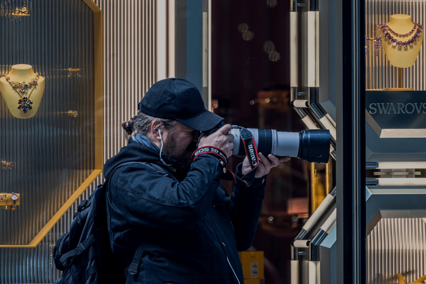 A man at the Swarovski store taking picture during a small group tour in New York City