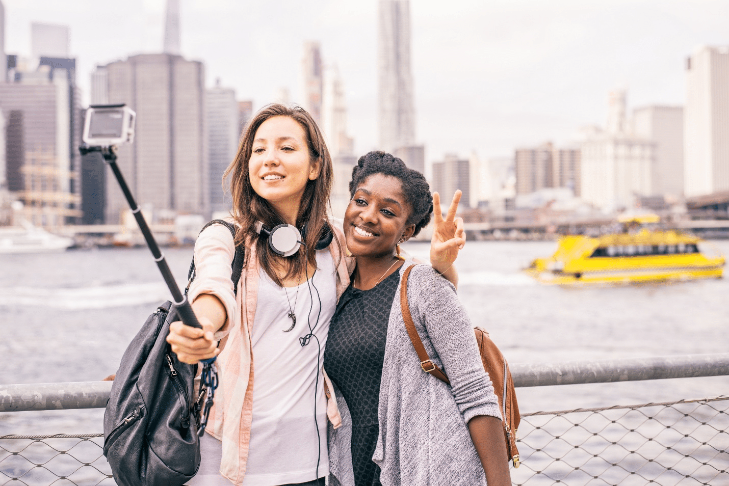 Women taking selfies during aNew York City travel guide