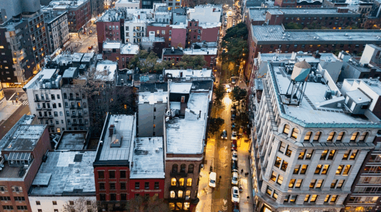 A street and buildings seen from above during a New York City travel guide
