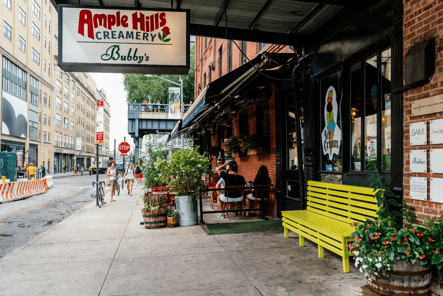 A storefront with a green bench seen during a New York City travel guide