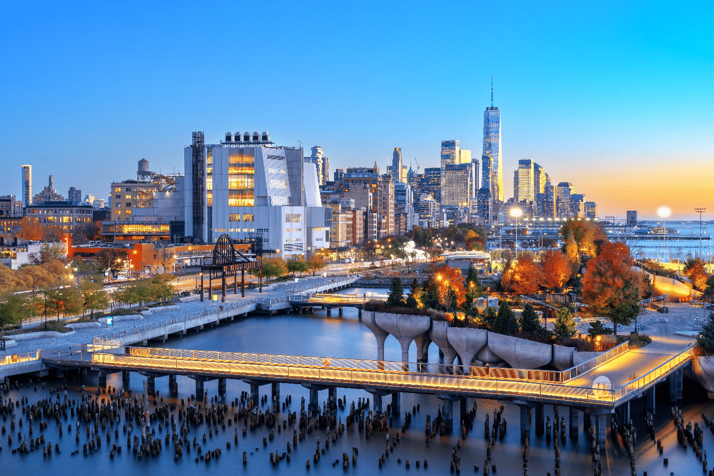 A bridge over water leading to a park during a New York City travel guide