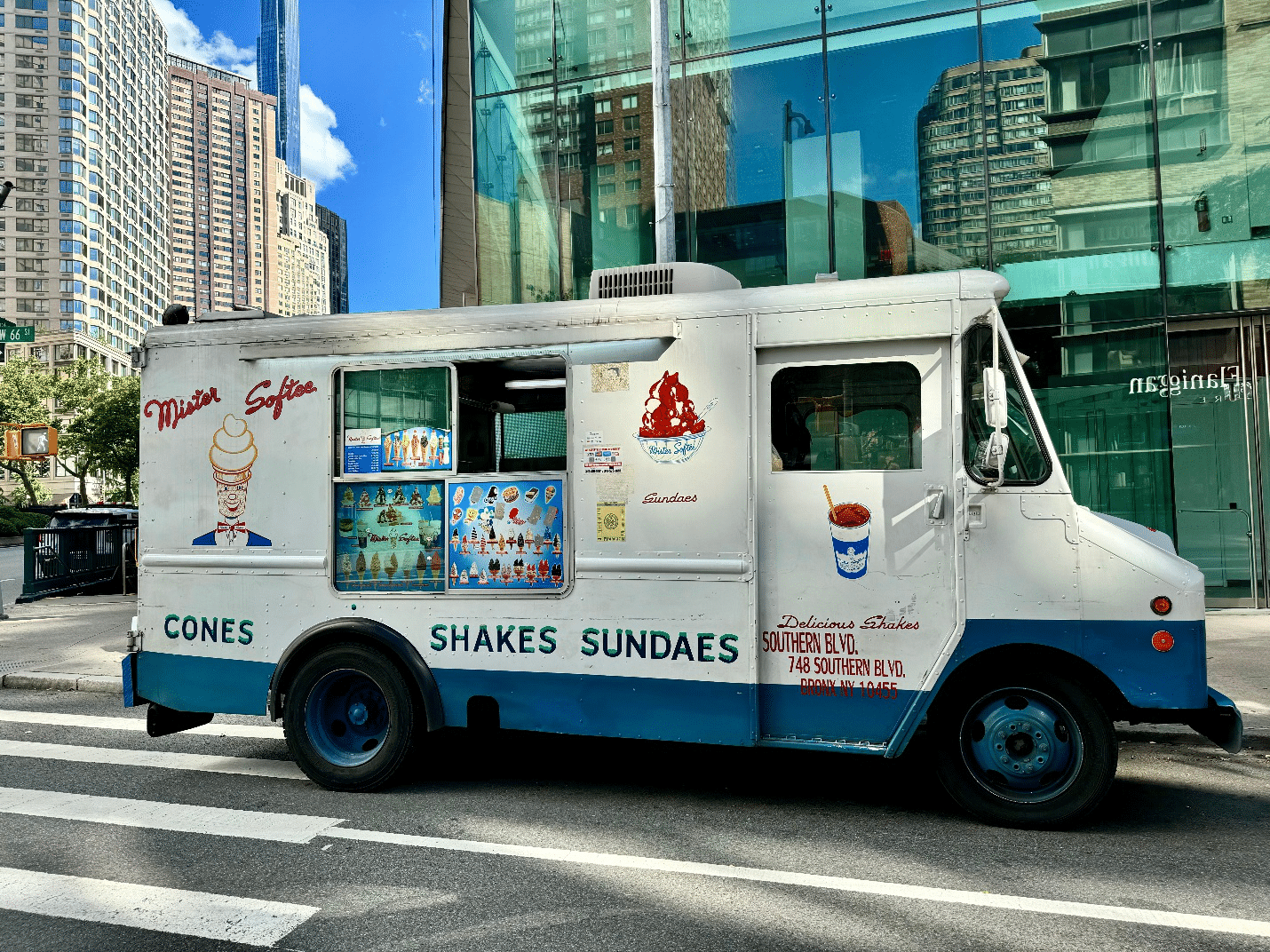 A white ice cream truck selling cones and shakes during a one-day sightseeing tour