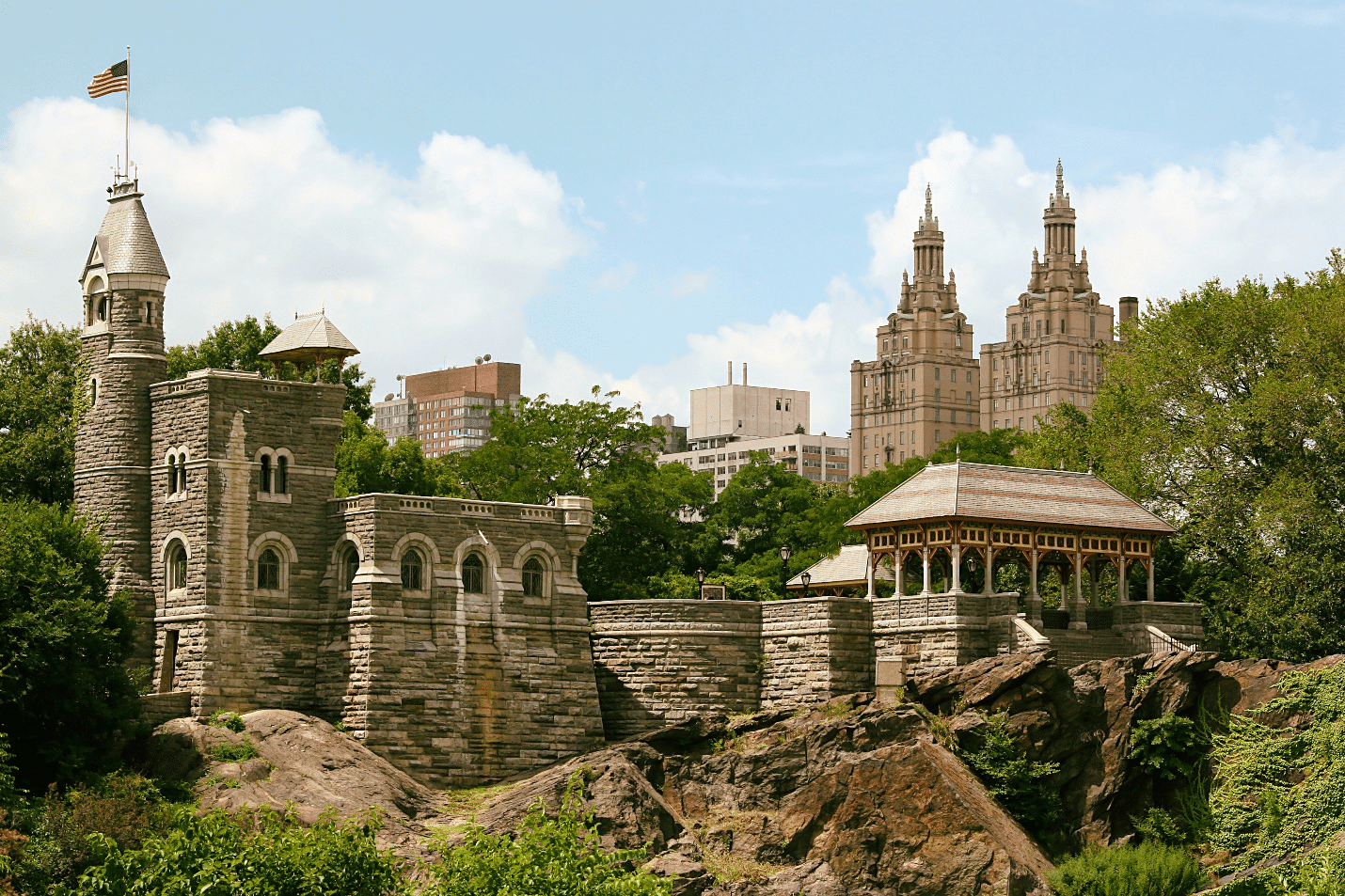 A large castle with city buildings in the back seen during a New York City travel guide