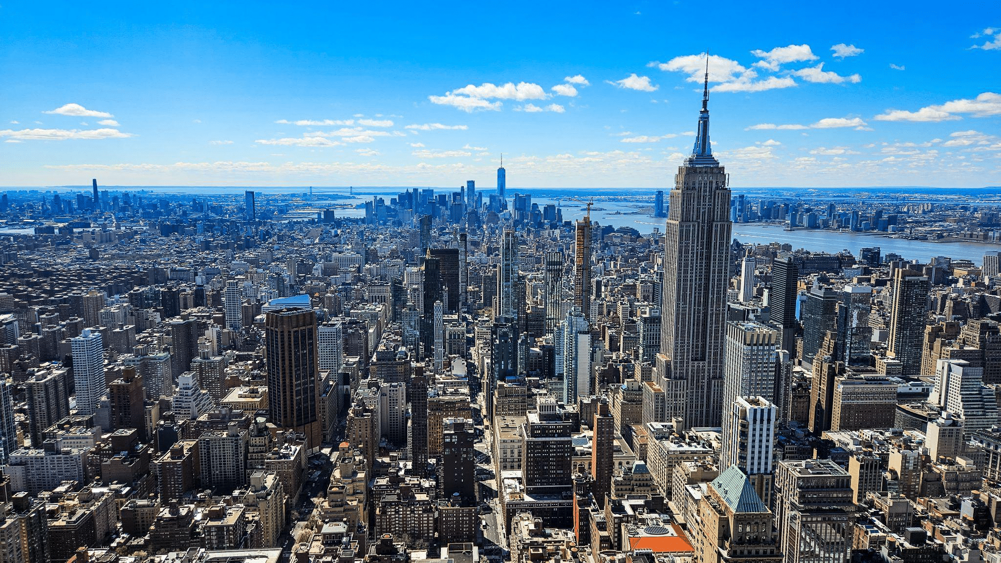 Panoramic view of New York City skyline with Empire State Building during the day.