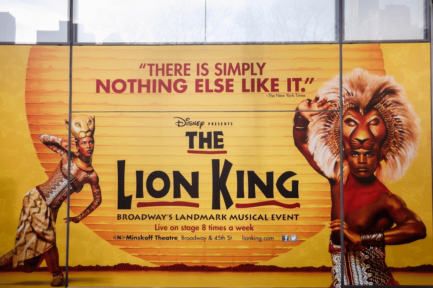 A board depicting the title and location of a Broadway play during a New York City travel guide
