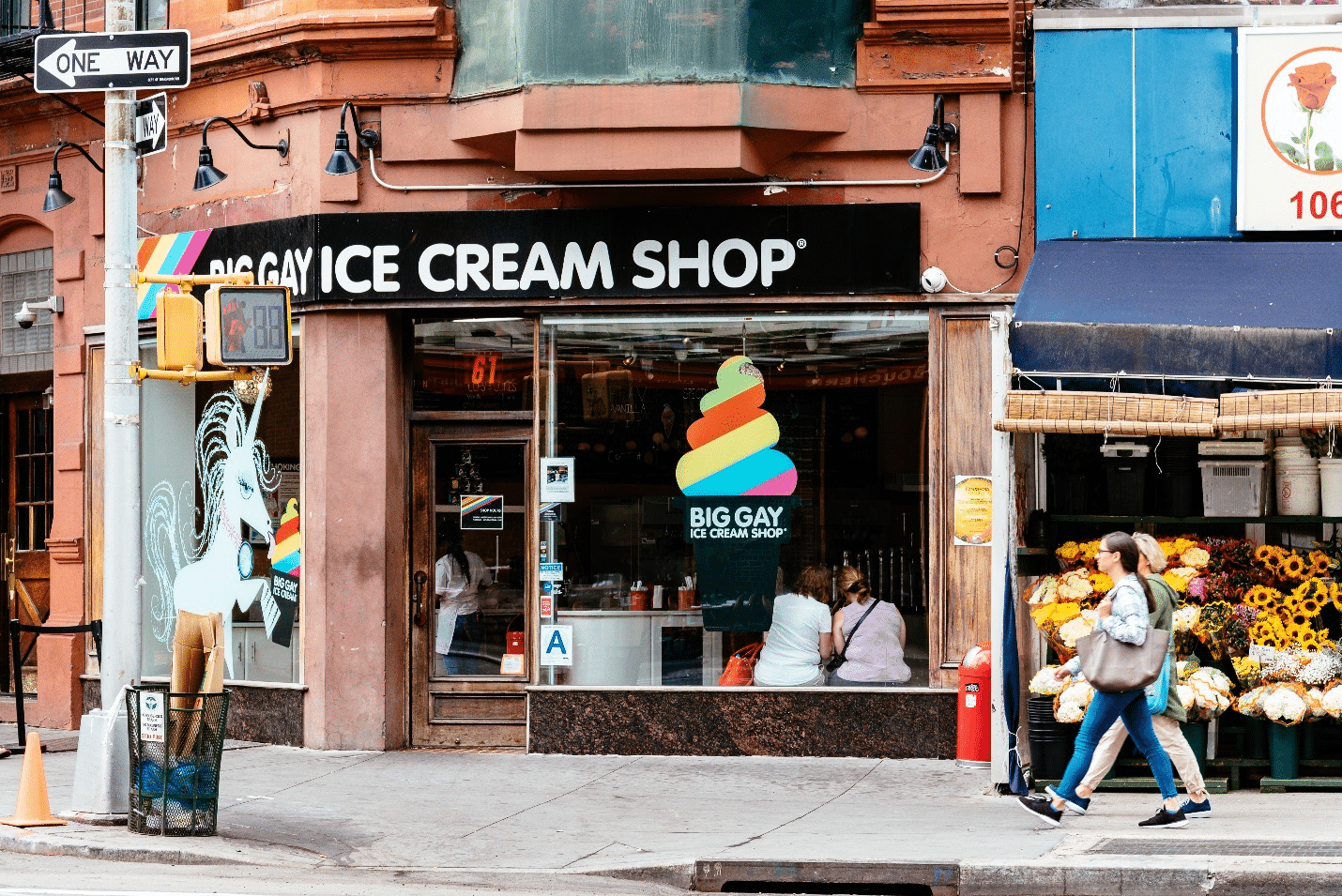 An ice cream store with a rainbow scoop on the window seen during a small group tour in New York City