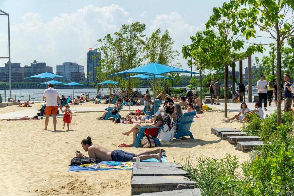 New York NY USA-May 26, 2024 Throngs of visitors on the beach at the Gansevoort Peninsula in Hudson River Park in New York enjoy the Memorial Day weekend