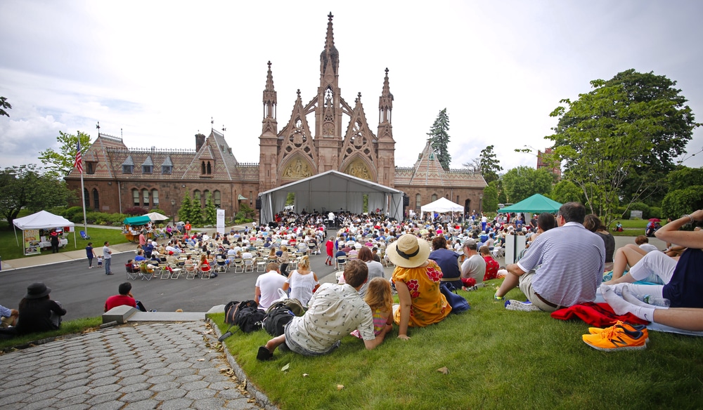 NEW YORK CITY - MAY 30 2016: Green-Wood Cemetery staged it's 28th annual Memorial Day concert by the Symphonic Orchestra at 3rd Street. Visitors fill hilltop overlooking Green-Wood north gate