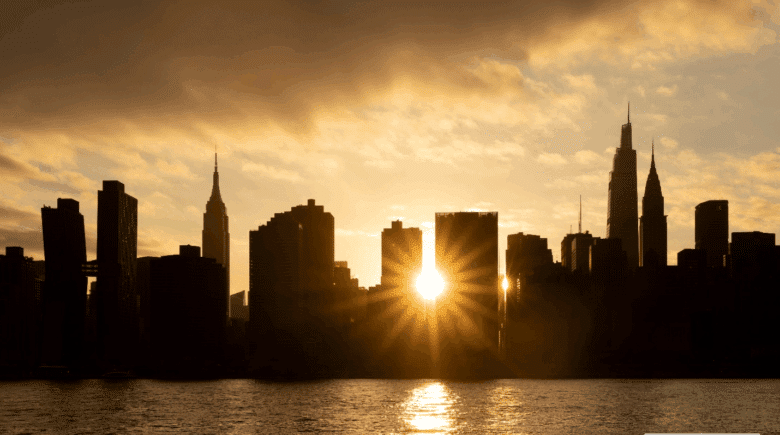 The sun shining from between buildings