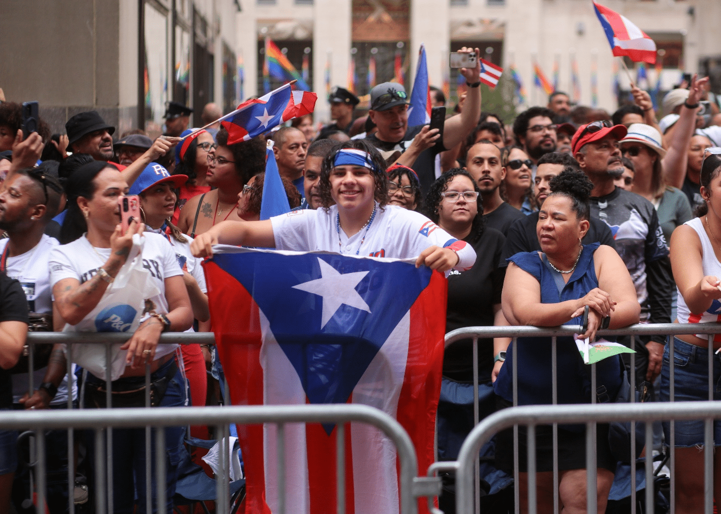 A man holding a Puerto Rican flag in a crowd