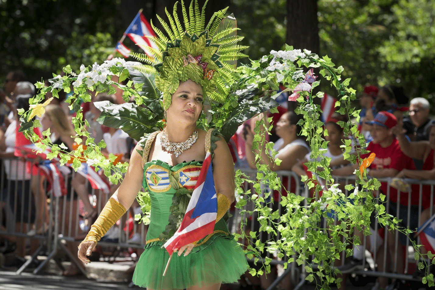 A woman in a green headdress with vines and plants