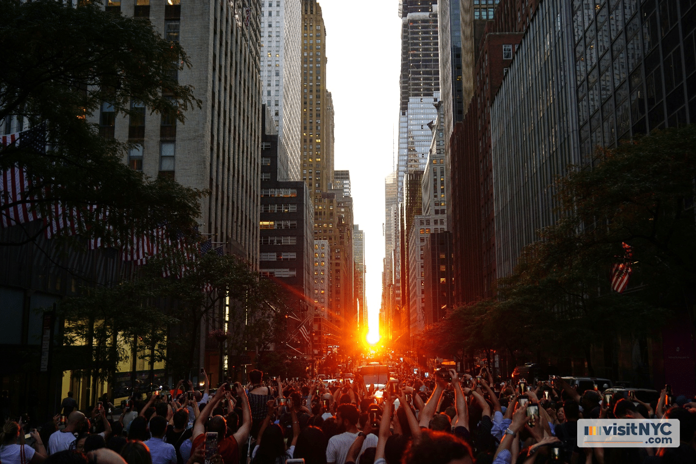 A crowd of people taking pictures of the Manhattanhenge