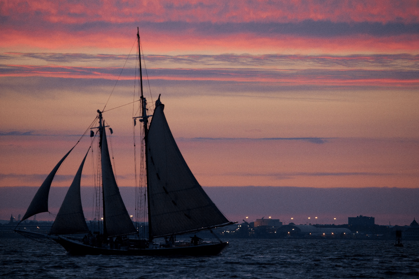 A boat sailing at sunset