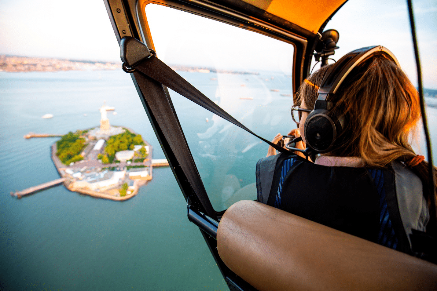 A woman looking out at an island from a helicopter