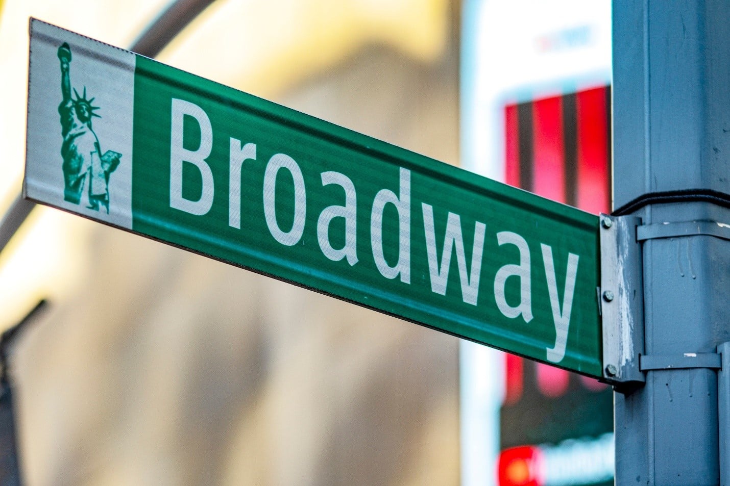 A green and white sign for Broadway