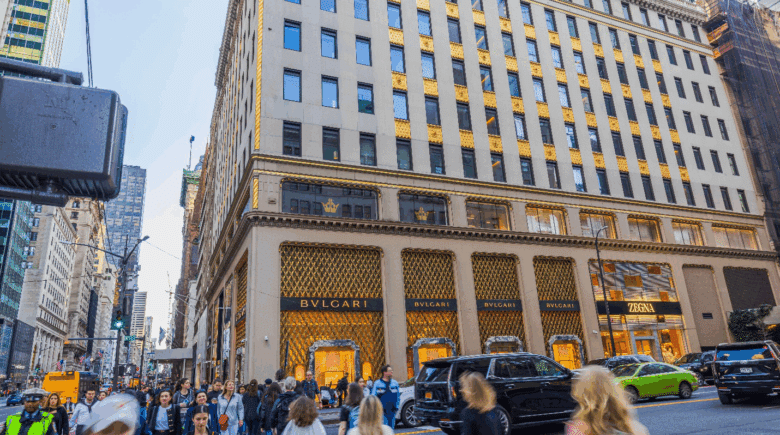 People passing by a large building