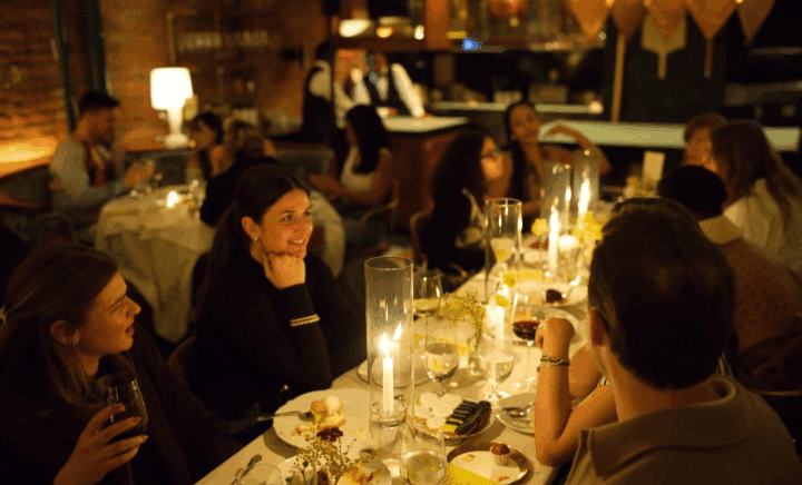A picture of people having dinner at a restaurant