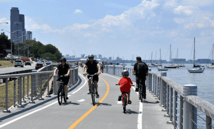 A picture of people cycling at the Hudson River