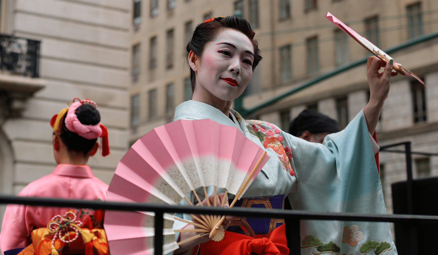 A Japanese woman holding a fan