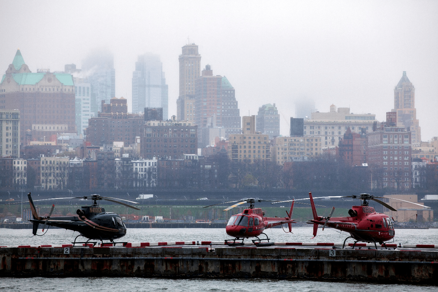 Three helicopters parked on the ground