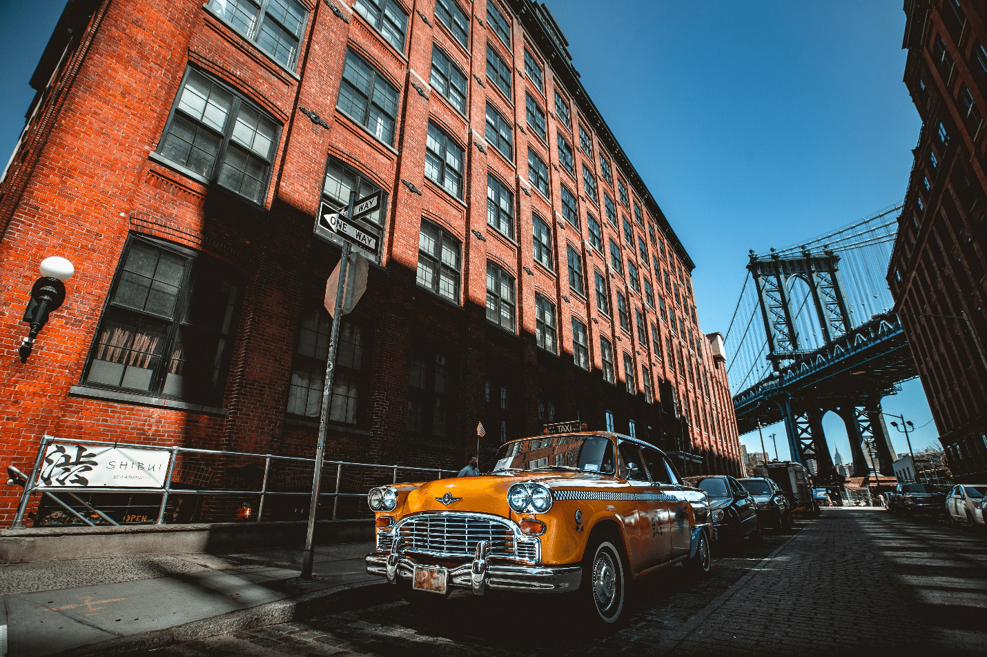 A car and red buildings in Dumbo’s Washington Street