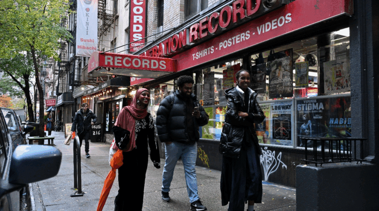 People walking past a record store in NYC