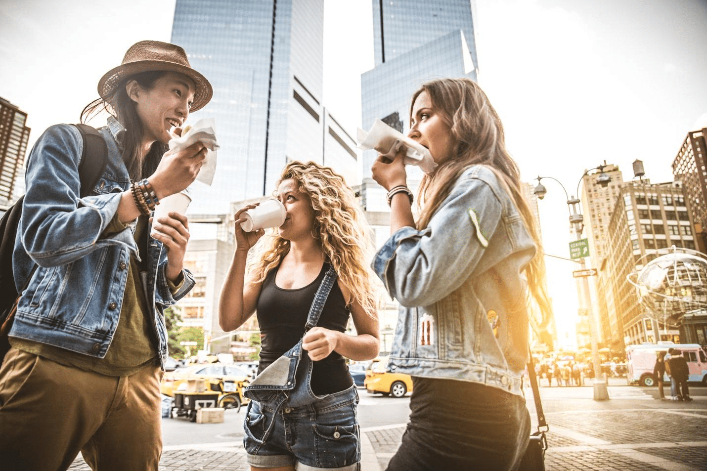 three women having coffee outdoors.