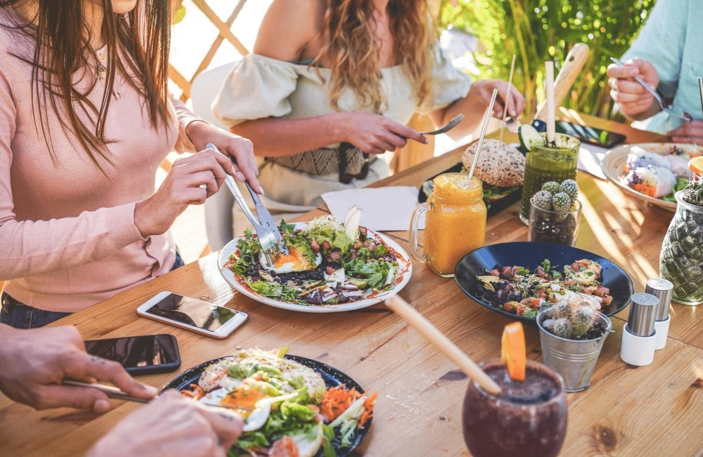 people eating salads in an outdoor space.
