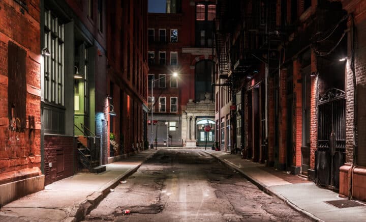 Historic New York City alley at night with ghostly ambiance, highlighting NYC haunted history and ghost tours.