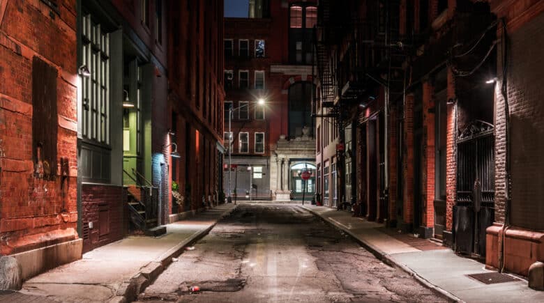 Historic New York City alley at night with ghostly ambiance, highlighting NYC haunted history and ghost tours.