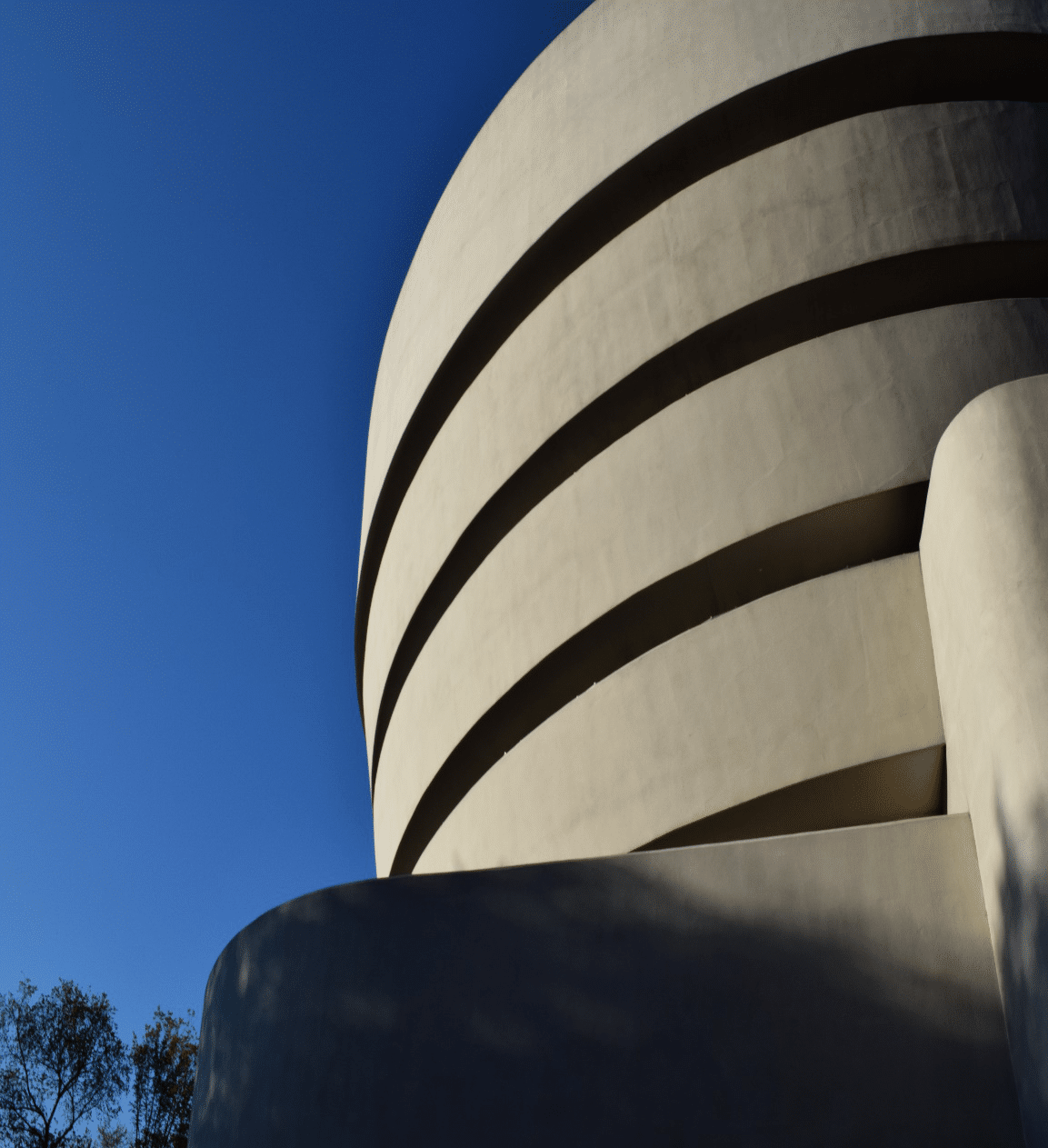 Exterior view of the Solomon R. Guggenheim Museum in New York City, highlighting Frank Lloyd Wright’s iconic modernist architecture featured in Archtober NYC tours.