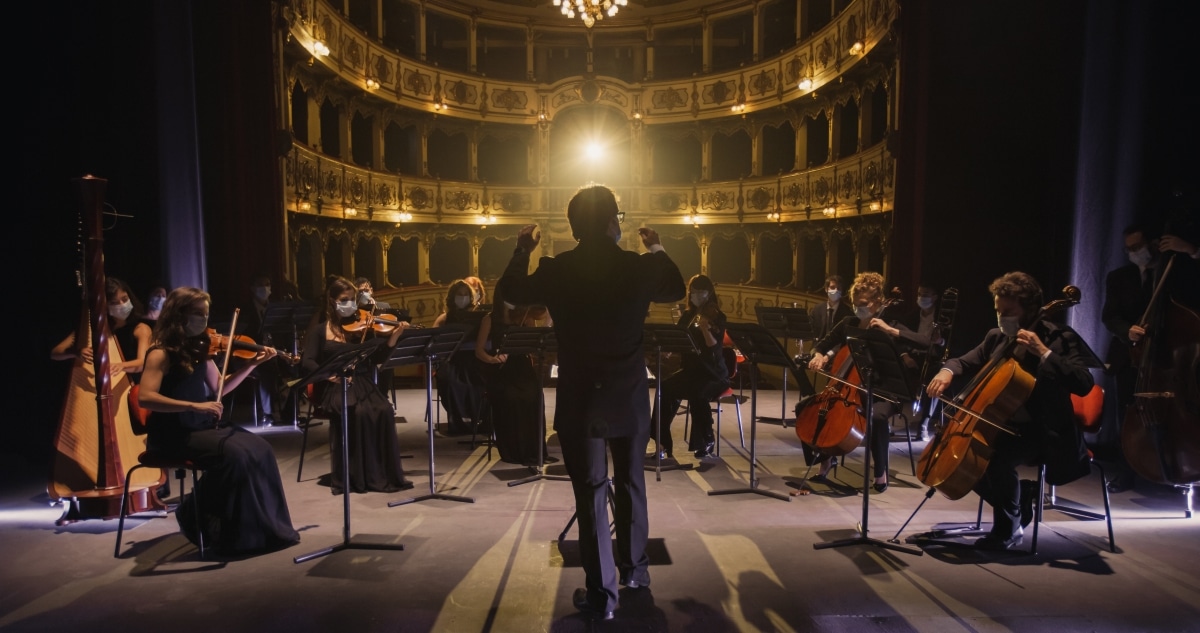 A conductor directing a symphony