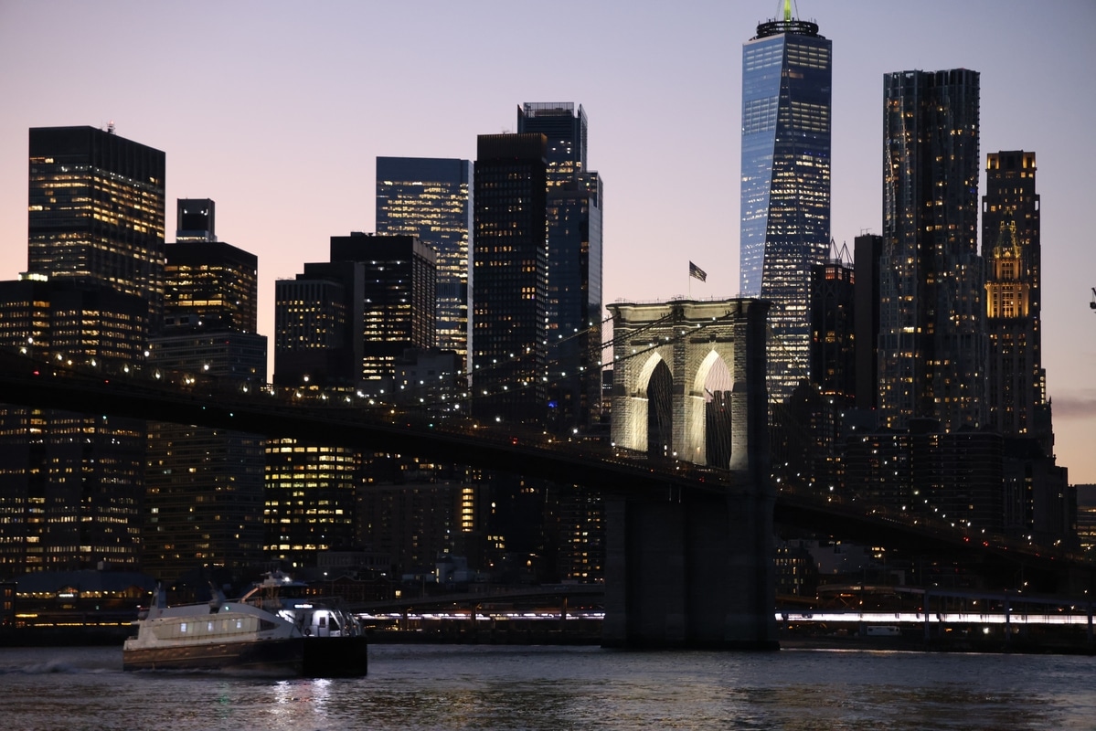 Brooklyn Bridge spanning the East River with Manhattan skyline in the background during autumn, New York City.
