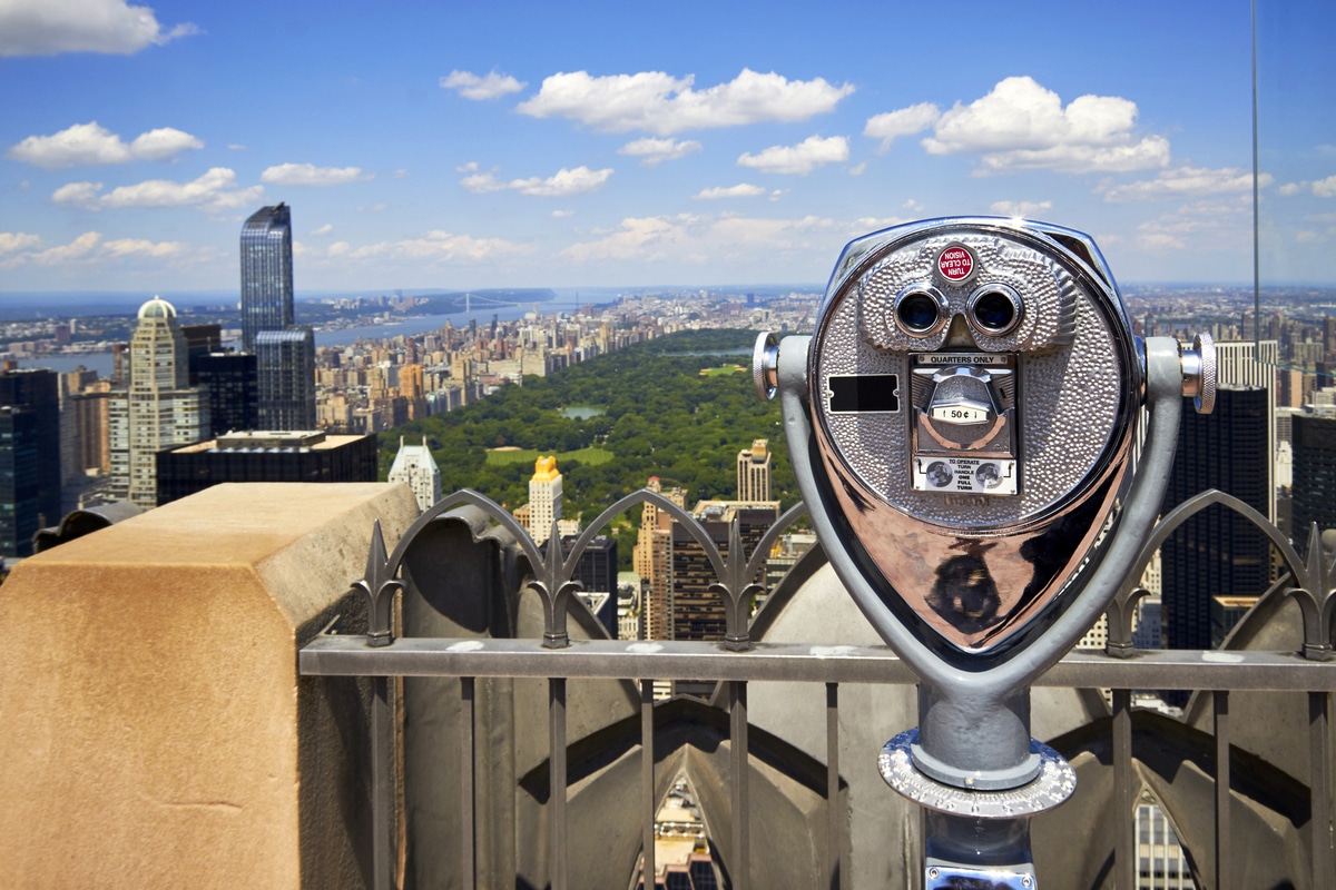 Public binoculars facing Rockefeller Center and the Midtown Manhattan skyline in New York City.
